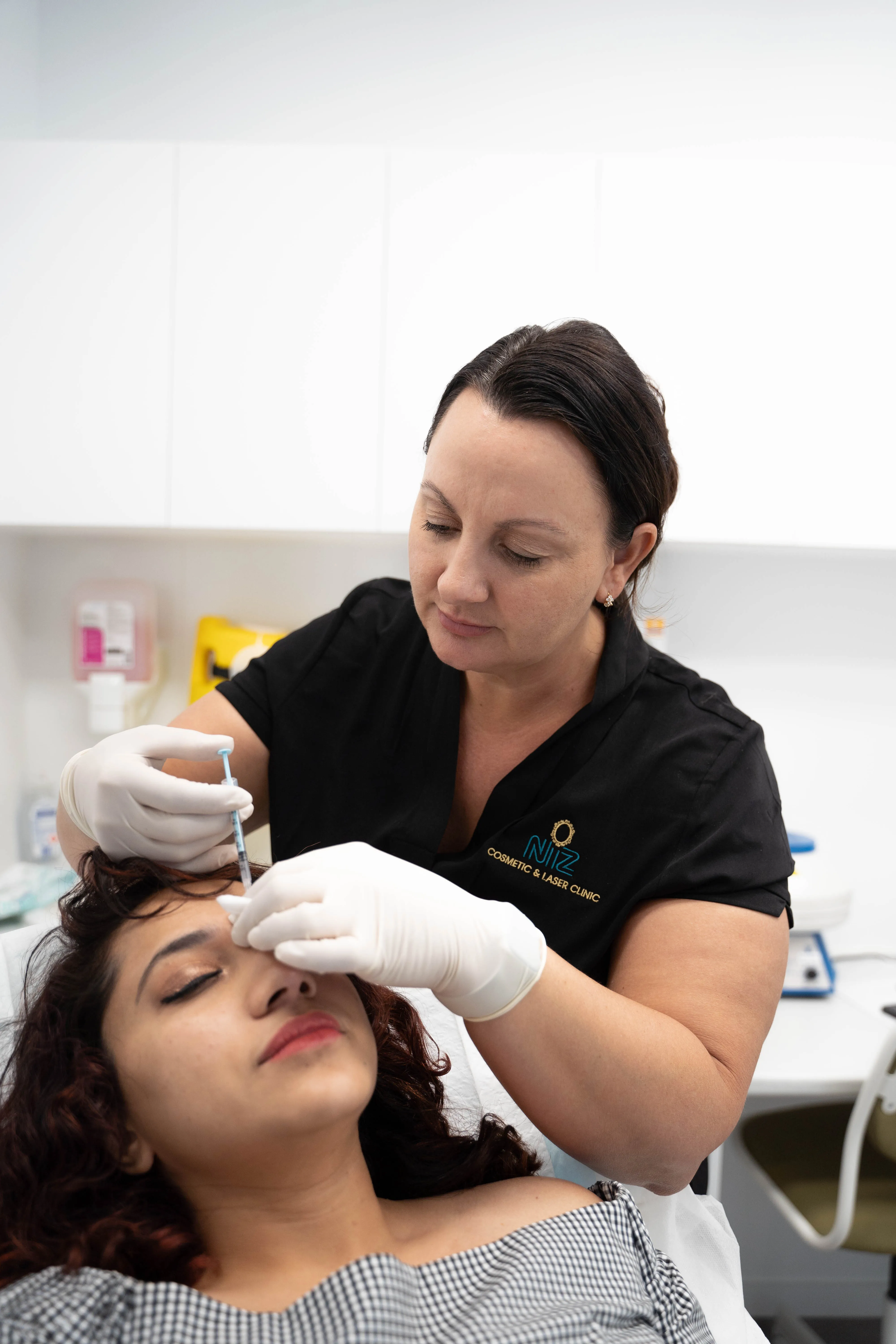 Nurse Mellisa administering liquid gold therapy injections for Nisla Rahim, the founder of NiZ Clinic, Gold coast - Australia