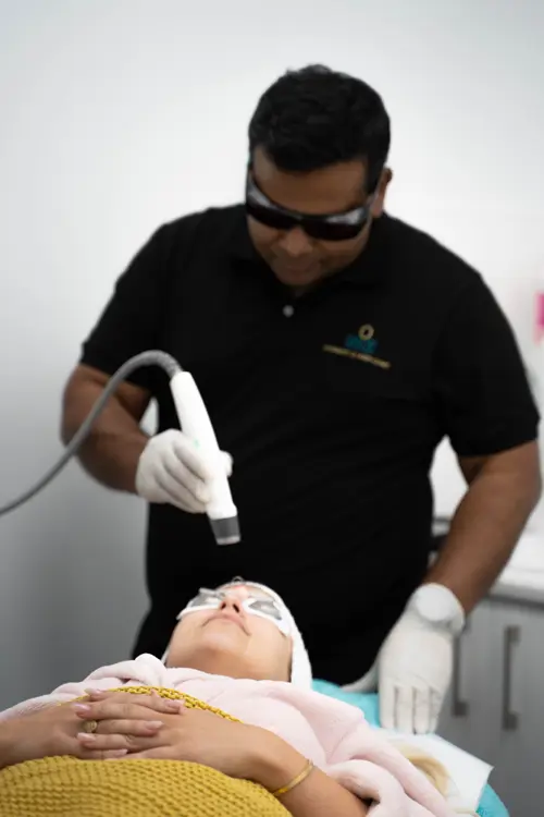 Dr Anwar Alackal Ismail performing a carbon facial for a female patient at NiZ Clinic, Gold coast - Australia